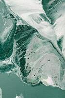 Acrylic Fluid Art. Natural Turquoise waves and frothy bubbles flow on canvas. Digital decor. Abstract stone background or texture photo
