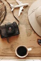 Top view of vintage world map with objects related to journey, excursions and tours. photo