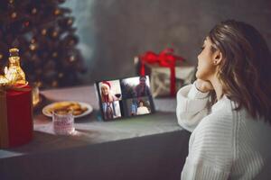 Happy young woman talking with friends on virtual zoom call photo