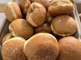 Close up donut with apple jam filling, a type of pastry made from leavened fried dough. photo