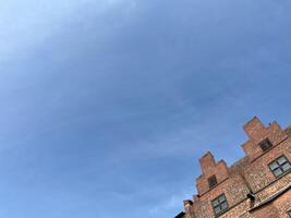 Clear blue sky with blurred old brick wall building. Red brick wall texture background. Brick wall background photo