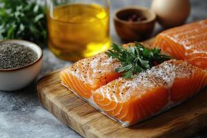 Fresh salmon fillet seasoned with salt and peppercorns on a cutting board photo