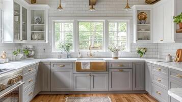Elegant kitchen with gray cabinetry and large windows photo