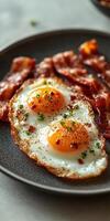 Delicious crispy bacon and fried eggs breakfast with thyme for seasoning photo