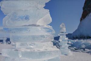 Pieces of ice lying on the ideal smooth ice of baikal with ice hummocks in the horizon photo