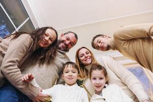 Happy large caucasian family with many children making selfie photo at home, looking at camera.