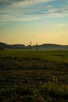 View of the field in the evening in the village. The clouds photo