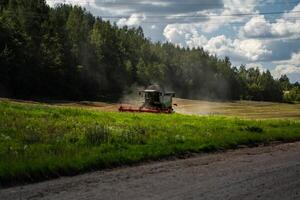 The harvester harvests in the field. The harvester is working in the field photo