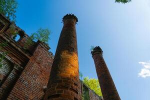 Two old, dilapidated, brick columns, bottom-up view photo