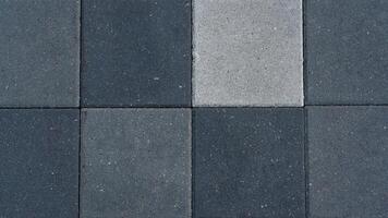 The paving slabs are square in shape. Square paving slabs of different colors photo