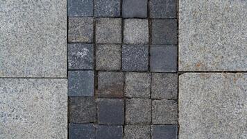 The paving slabs are square in shape. Square paving slabs photo