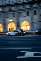 the effect of blurring in the movement of a motorcycle, in the evening in the city photo