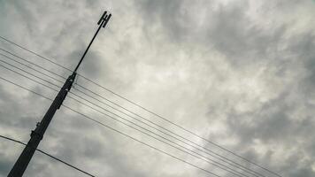 Support of a street lamp with a view of the cloudy sky photo