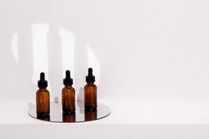 Group of brown bottles and their reflection on a mirror surface photo