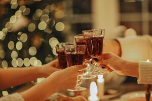 Family friends have fun together in winter eating food on a wooden table photo