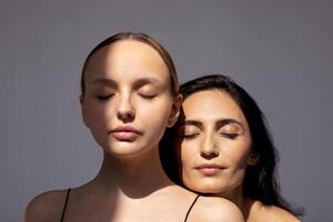 two women with their eyes closed and one with her eyes closed photo