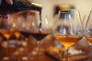 Glass goblets placed in rows on table during wine tasting procedure in restaurant photo