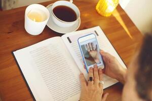 Fortune teller reading palm lines during online palmistry consultation photo