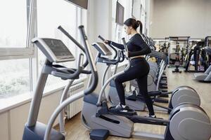 Doing cardio on the treadmill. Running on a treadmill. photo