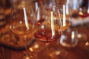 Glass goblets placed in rows on table during wine tasting procedure in restaurant photo