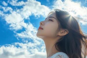 Beautiful woman smiling hair blowing in the wind blue sky background. photo