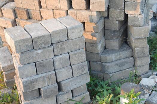 stacks of concrete bricks or blocks arranged on the ground photo