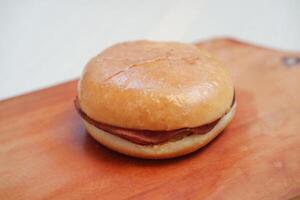 Hamburger bun on a cutting board. Close up. top view photo