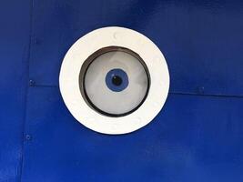 An eye in a round porthole, the concept of the all-seeing eye photo