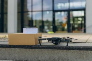 Modern technological delivery innovation - drone fast delivery concept, two multicopters and box photo