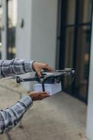 Fast and safe delivery. A drone delivers a gift to a girl, contactless delivery photo