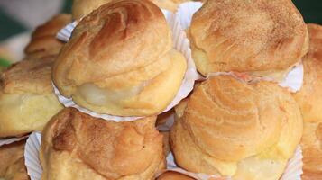 Slightly sweet and aromatic eclairs are stacked photo