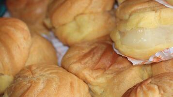Slightly sweet and aromatic eclairs are stacked photo