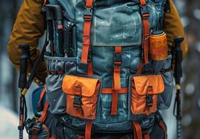 A detailed shot of a hiking backpack with various compartments and camping tools photo