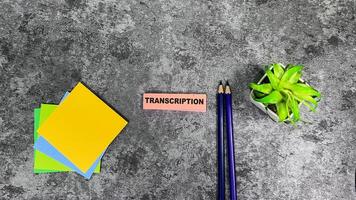Concept of Transcription write on sticky notes isolated on Wooden Table. photo