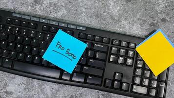 Concept of Pro Bono write on sticky notes isolated on Wooden Table. photo