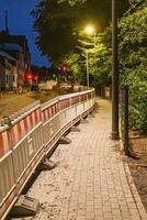 Roadworks with barriers and warning lights at night photo