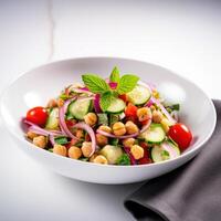 Vegetarian chickpea salad prepared with tomatoes, cucumber, red onion, cress salad and arugula, White Background, photo