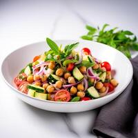 Vegetarian chickpea salad prepared with tomatoes, cucumber, red onion, cress salad and arugula, White Background, photo