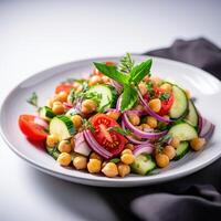 Vegetarian chickpea salad prepared with tomatoes, cucumber, red onion, cress salad and arugula, White Background, photo
