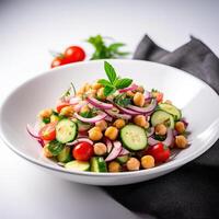 Vegetarian chickpea salad prepared with tomatoes, cucumber, red onion, cress salad and arugula, White Background, photo