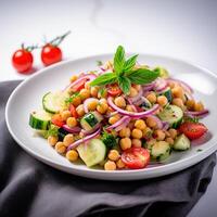 Vegetarian chickpea salad prepared with tomatoes, cucumber, red onion, cress salad and arugula, White Background, photo