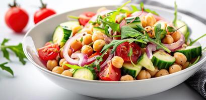 Vegetarian chickpea salad prepared with tomatoes, cucumber, red onion, cress salad and arugula, White Background, photo