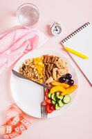 Set of healthy food for individual meal plan on plate on table top and vertical view photo