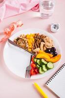 Set of healthy food for individual meal plan on plate on table vertical view photo
