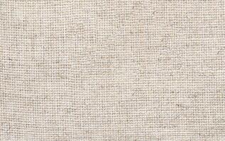 Natural Linen Material Textile Canvas Fabric Texture Background Close-up Detail of Fabric Natural Color Hemp Material Pattern Design Wallpaper. Can be Used as Background or For Graphic Design photo