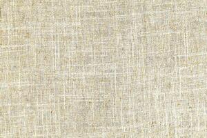 Natural Linen Material Textile Canvas Fabric Texture Background Close-up Detail of Fabric Natural Color Hemp Material Pattern Design Wallpaper. Can be Used as Background or For Graphic Design photo