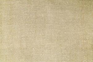 Natural Linen Material Textile Canvas Fabric Texture Background Close-up Detail of Fabric Natural Color Hemp Material Pattern Design Wallpaper. Can be Used as Background or For Graphic Design photo