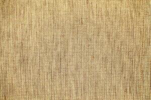 Natural Linen Material Textile Canvas Fabric Texture Background Close-up Detail of Fabric Natural Color Hemp Material Pattern Design Wallpaper. Can be Used as Background or For Graphic Design photo