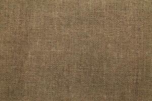 Natural Linen Material Textile Canvas Fabric Texture Background Close-up Detail of Fabric Natural Color Hemp Material Pattern Design Wallpaper. Can be Used as Background or For Graphic Design photo