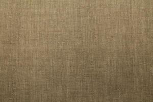 Natural Linen Material Textile Canvas Fabric Texture Background Close-up Detail of Fabric Natural Color Hemp Material Pattern Design Wallpaper. Can be Used as Background or For Graphic Design photo